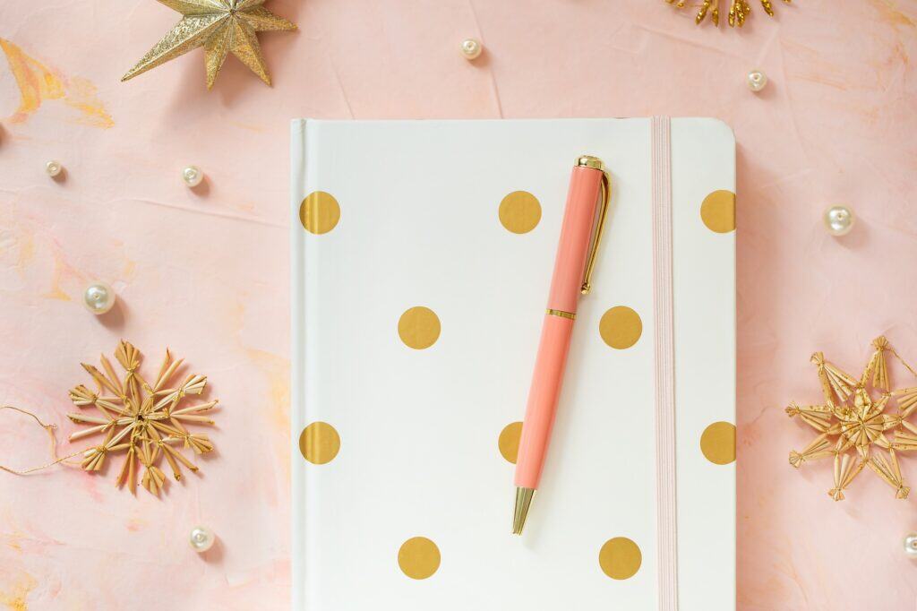 Customized pen on top of a customized book for a printing service. Zippy Printz